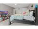 This carpeted bedroom features a ceiling fan and double door closet at 7350 Gold King Way, Indianapolis, IN 46259