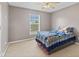This bedroom offers neutral colors and a window with outdoor views at 7350 Gold King Way, Indianapolis, IN 46259
