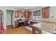 Well-equipped kitchen featuring stainless steel appliances, granite counters, and dark wood cabinetry at 7350 Gold King Way, Indianapolis, IN 46259