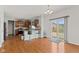 Spacious open concept dining and kitchen area with stainless steel appliances, hardwood flooring, and sliding door to deck at 7350 Gold King Way, Indianapolis, IN 46259