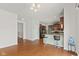 An open-concept floorplan featuring hardwood floors connects the dining room to the kitchen with breakfast bar seating at 7350 Gold King Way, Indianapolis, IN 46259