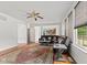 Bright living room with a sectional sofa, area rug, hardwood flooring, and large windows at 7350 Gold King Way, Indianapolis, IN 46259