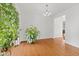 Bright living room with hardwood floors and plants next to the front door at 7350 Gold King Way, Indianapolis, IN 46259