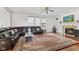 A beautiful living room with dark leather furniture, fire place, and large decorative rug on hardwood floors at 7350 Gold King Way, Indianapolis, IN 46259