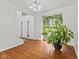 Bright living room with hardwood floors and plants next to the front door at 7350 Gold King Way, Indianapolis, IN 46259