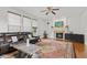Open concept living room with fireplace, hardwood floors, a leather sectional and large windows for natural light at 7350 Gold King Way, Indianapolis, IN 46259