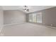 Spacious main bedroom with neutral tones, vaulted ceiling, carpet, and large windows at 7350 Gold King Way, Indianapolis, IN 46259