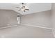 Large carpeted main bedroom with neutral gray walls and a ceiling fan at 7350 Gold King Way, Indianapolis, IN 46259