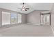 Neutral bedroom features vaulted ceiling, ceiling fan, and natural light from the windows at 7350 Gold King Way, Indianapolis, IN 46259