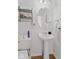 A white pedestal sink and elongated toilet sit on hardwood floors in this powder room at 7350 Gold King Way, Indianapolis, IN 46259