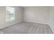 Bedroom with neutral carpet and large window overlooking the backyard pond at 7572 Wymm Ln, Ingalls, IN 46048
