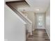 A foyer with a staircase and view to the front door and wood-look vinyl plank flooring at 7572 Wymm Ln, Ingalls, IN 46048