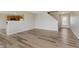 Open-concept living area, wood-look floors, connecting to the kitchen, and a staircase at 7572 Wymm Ln, Ingalls, IN 46048