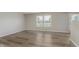 Spacious living room with neutral walls, vinyl plank flooring, and natural light at 7572 Wymm Ln, Ingalls, IN 46048