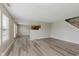 Open-concept living area with kitchen view, featuring sleek vinyl plank flooring at 7572 Wymm Ln, Ingalls, IN 46048