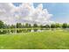 Scenic view of pond surrounded by lush green grass and mature trees at 7572 Wymm Ln, Ingalls, IN 46048