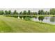 Scenic view of pond surrounded by green grass and various trees at 7572 Wymm Ln, Ingalls, IN 46048