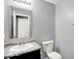 Cozy half bathroom with a single sink and commode at 7865 Danube St, Indianapolis, IN 46239