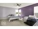 Spacious bedroom featuring two beds, large windows, and a ceiling fan providing ample light and comfort at 7865 Danube St, Indianapolis, IN 46239