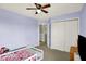 Lovely bedroom with a ceiling fan, closet, and easy access to the hallway at 7865 Danube St, Indianapolis, IN 46239