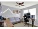 Spacious bedroom featuring a well-lit gaming setup, a comfortable sofa, and a modern ceiling fan at 7865 Danube St, Indianapolis, IN 46239