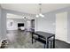 Dining area with a dark table and bench, adjacent to the living room at 7865 Danube St, Indianapolis, IN 46239