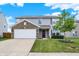 Charming two-story home with brick accents, a two-car garage, and lush front yard landscaping at 7865 Danube St, Indianapolis, IN 46239