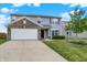 Attractive home featuring a two-car garage, well-maintained lawn, and inviting front entrance at 7865 Danube St, Indianapolis, IN 46239
