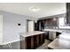 Bright kitchen with a center island, dark cabinets, and stainless steel appliances at 7865 Danube St, Indianapolis, IN 46239