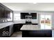 Modern kitchen with stainless steel appliances and island overlooking the backyard at 7865 Danube St, Indianapolis, IN 46239