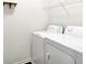 Functional laundry area featuring a white washer and dryer, plus a wire rack for efficient storage solutions at 7865 Danube St, Indianapolis, IN 46239