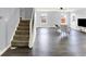 Bright living room with staircase, modern chairs and light-filled windows at 7865 Danube St, Indianapolis, IN 46239