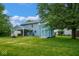 View of the two-story home with a covered patio and shed in the green, well-maintained backyard at 8047 Red Barn Cir, Indianapolis, IN 46239