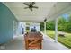 Covered patio with a dining table, adjacent to a spacious backyard with a shed and greenery at 8047 Red Barn Cir, Indianapolis, IN 46239