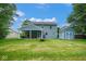 Expansive backyard featuring a covered patio, well-maintained lawn, shed, and two-story home at 8047 Red Barn Cir, Indianapolis, IN 46239