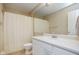 Neutral bathroom featuring a shower with curtain, toilet, and vanity with a white countertop and large mirror at 8047 Red Barn Cir, Indianapolis, IN 46239