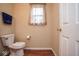 Cozy powder room featuring a toilet, vanity, and neutral decor at 8047 Red Barn Cir, Indianapolis, IN 46239