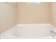 Corner soaking tub with tile surround and chrome fixtures at 8047 Red Barn Cir, Indianapolis, IN 46239