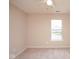 This bedroom offers neutral walls, carpet flooring, and a window with views of the neighborhood at 8047 Red Barn Cir, Indianapolis, IN 46239