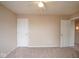 This carpeted bedroom includes two entryways and neutral colored walls at 8047 Red Barn Cir, Indianapolis, IN 46239