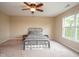 This bedroom has a ceiling fan and natural light from a large window at 8047 Red Barn Cir, Indianapolis, IN 46239