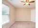 This carpeted bedroom features natural light, a ceiling fan, and neutral-colored walls at 8047 Red Barn Cir, Indianapolis, IN 46239