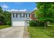Charming two-story home with blue siding, brick accents, and attached two-car garage at 8047 Red Barn Cir, Indianapolis, IN 46239