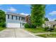 Lovely two-story home with a mix of blue siding and brick, complemented by a spacious driveway at 8047 Red Barn Cir, Indianapolis, IN 46239