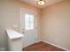 View of the foyer with hardwood floors and glass paneled door at 8047 Red Barn Cir, Indianapolis, IN 46239