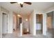 View of the carpeted hallway with open doorways to a laundry room, bathroom, and an upper staircase at 8047 Red Barn Cir, Indianapolis, IN 46239