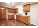 Bright kitchen features wooden cabinets, white countertops, white appliances and wood-look flooring at 8047 Red Barn Cir, Indianapolis, IN 46239
