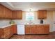 Spacious kitchen with white counter tops and wood cabinets at 8047 Red Barn Cir, Indianapolis, IN 46239