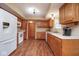 Functional kitchen with white appliances and wood cabinets at 8047 Red Barn Cir, Indianapolis, IN 46239