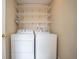 Laundry room equipped with a white washer and dryer, and multiple wire shelves for storage at 8047 Red Barn Cir, Indianapolis, IN 46239